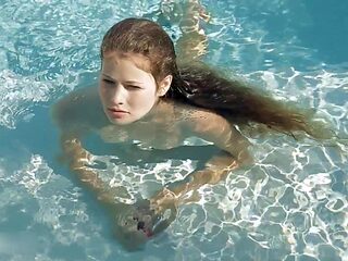 Beautiful Redhead's Playful Charm by the Poolside