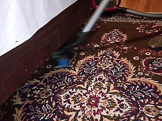 Ellie cleans with a vacuum cleaner