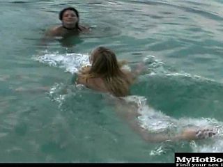 Two seductive charmers enjoy sharing a massive dick at the beach