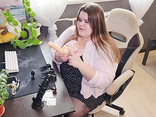 Russian Sex Shop Chubby Assistant Shows a Collection of Dildos and Anal Plugs