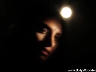 Exotic Indian brunette seductively exposes her body in a traditional show