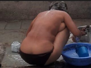 My elder sister-in-law's stepsister is bathing naked in red tights in the open bathroom at my house