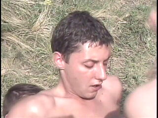 Sexy cougar sucks two cocks in the grass then they all fuck 