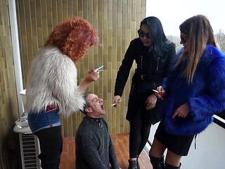 Three femdom chicks smoking and using him as ashtrey