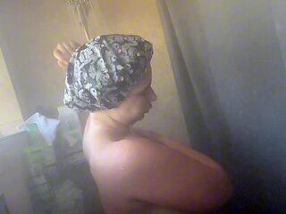 Chubby goth girl takes a steamy shower with big natural tits and a round ass.