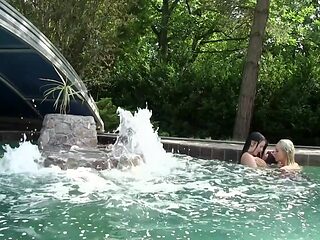 Outdoor lesbians explore passion and warmth by the pool