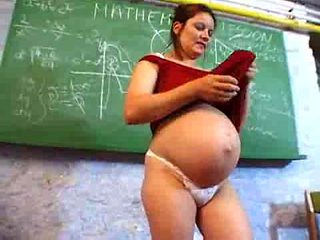 Pegnant teacher masturbates in her desk