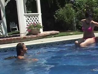 Bored sunbathing lesbian friends are messing with their privates in the outdoor pool