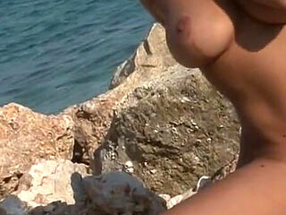 Seductive Brunette Babe Strips Naked on Rocky Beach