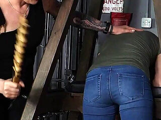 Slave Mila's Feet Dangle and Quiver as Mistress Baton Breaks in Heavy Wooden Paddle Over Her Jeans and Bare