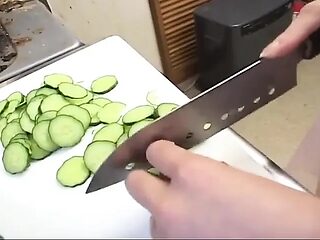 Insatiable housewife drenches cucumber in kitchen sink