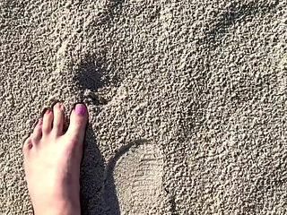 Comparing Size 16 Feet to Sand Prints at the Beach