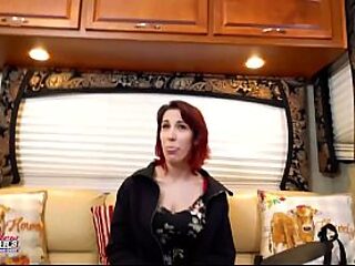 Curvy redhead Scarlett Foxx gives a sensual handjob and deepthroat BJ