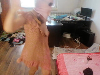 Amateur woman has fun trying on clothes and cutting them.