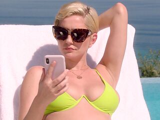 Skye's naturally busty blonde body glistens under the sun in a teeny weeny bikini