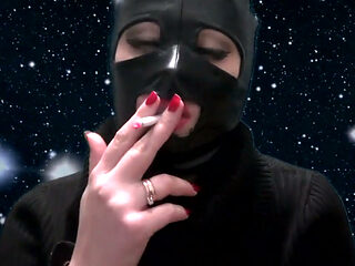 Smoking and teasing you in a latex mask